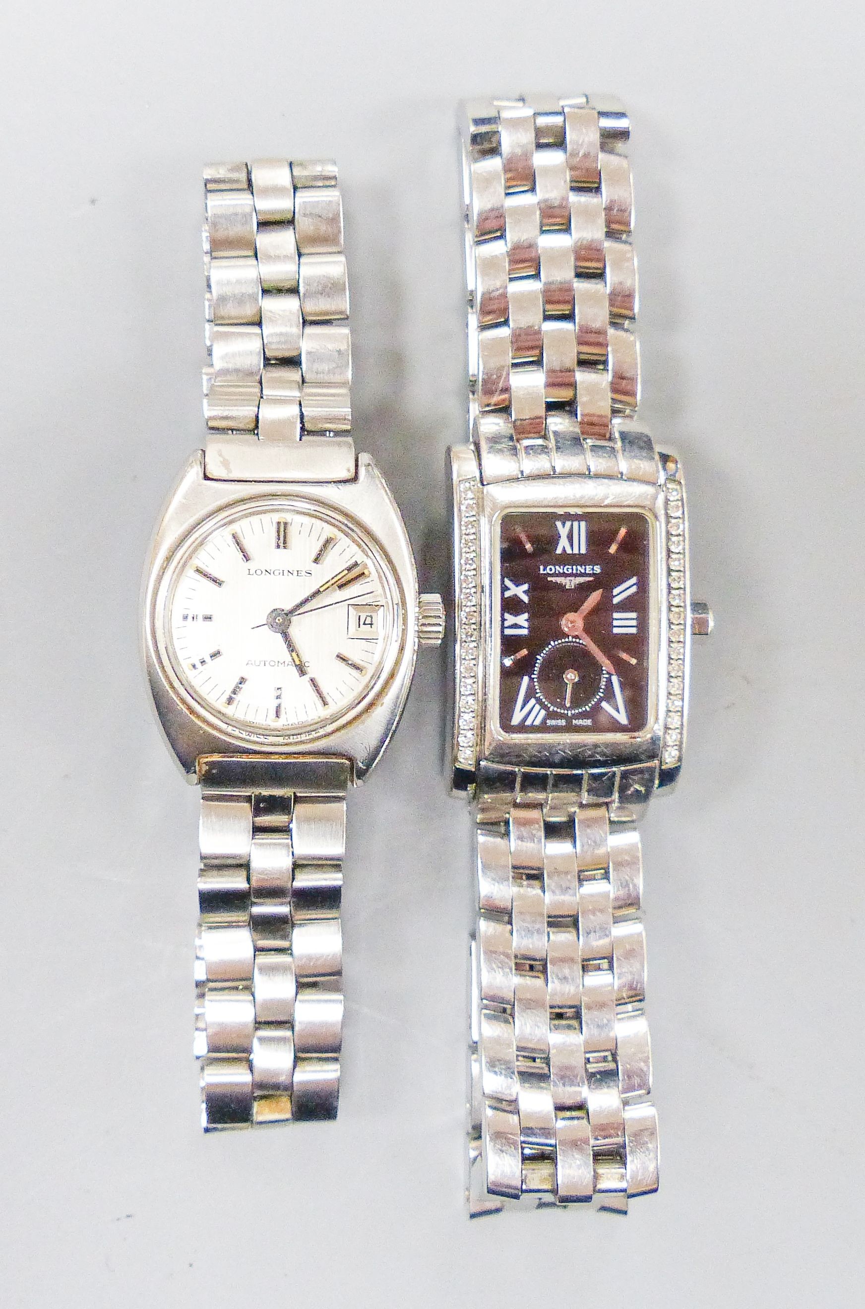 Two lady's stainless steel Longines wrist watches, one automatic and one with diamond set rectangular bezel.